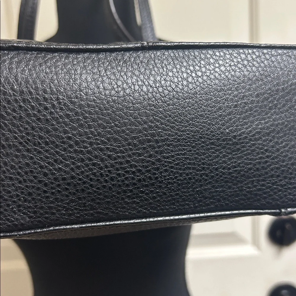 Anne Klein Black leather Tote with size pocket and adjustable straps. 13”x9 1/2”